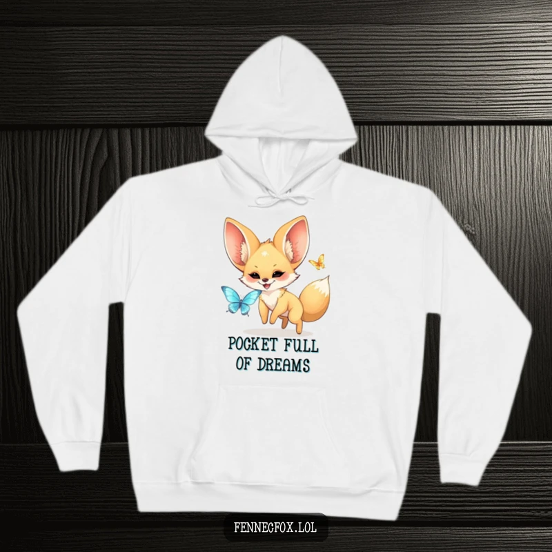 Funny kawaii fennec fox with large ears joyfully chasing a shimmering butterfly, depicted on a cozy hoodie for a humorous touch.