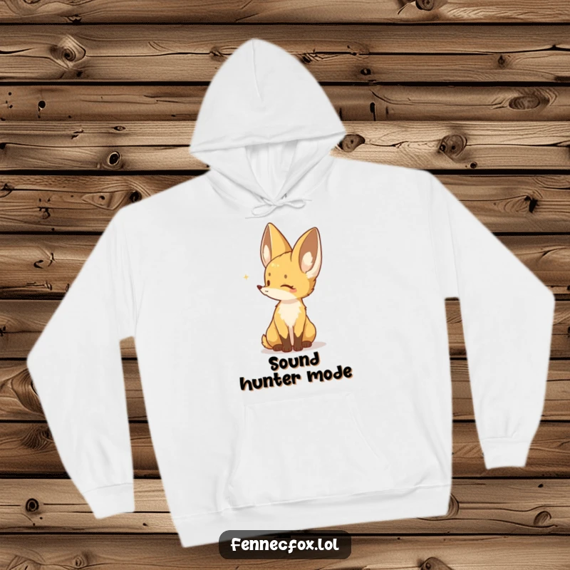 Funny hoodie depicting a Fennec fox with its large ears perked, listening intently to a subtle, faraway sound, exuding alertness.