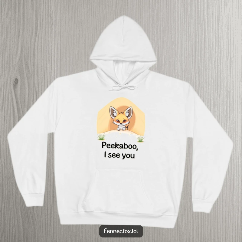 Funny fennec fox hoodie showing a cartoon desert fox slyly peeking over a huge sand dune, a playful desert scene.
