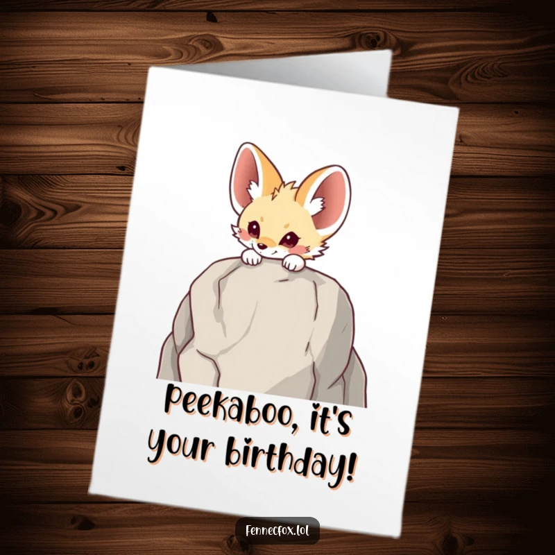 Funny Free Printable birthday card with a fennec fox curiously peeking over a tall rock, ready to surprise.