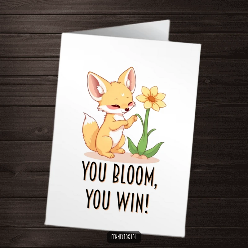 Funny Free Printable Congratulations Card: Adorable fennec fox playfully batting a desert flower, celebrating achievements with charm. A unique downloadable.
