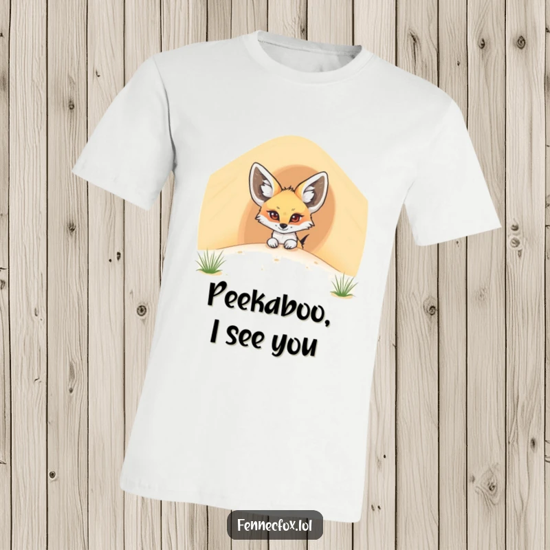 Funny fennec fox t-shirt with a cartoon desert fox peeking comically from behind a giant sand dune, full of curiosity.
