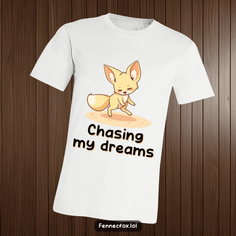 Funny fennec fox t-shirt depicting a playful fennec fox chasing its tail in a sandy circle, symbolizing fun and adorable antics.